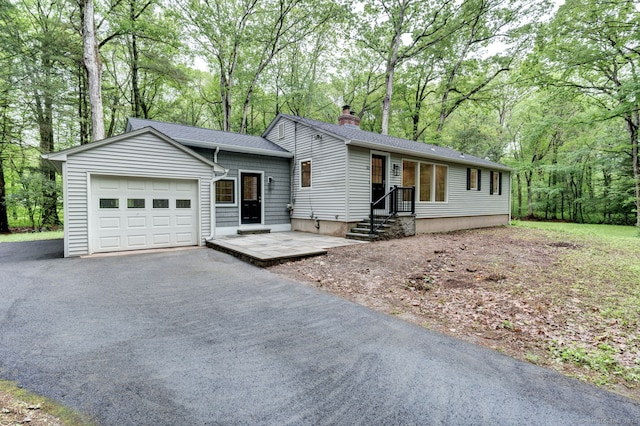 33 White Oak Ln, Woodbridge, CT 06525 - ranch-style home featuring a chimney, a garage, asphalt driveway, roof with shingles, and view of scattered trees