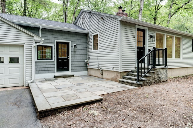 33 White Oak Ln, Woodbridge, CT 06525 - rear view of property featuring a garage, a chimney, and roof with shingles