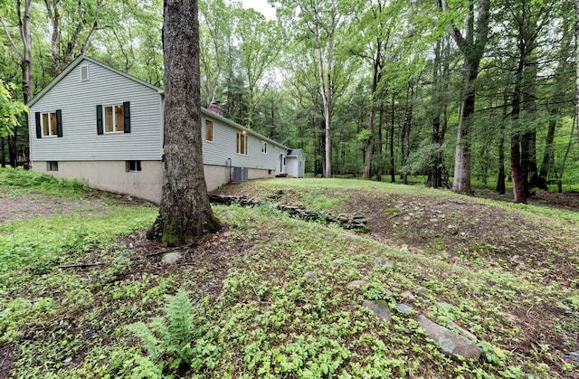 33 White Oak Ln, Woodbridge, CT 06525 - view of yard with central AC unit and a view of trees