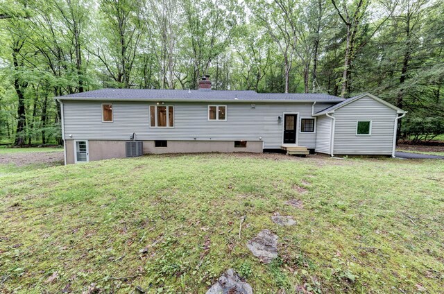 33 White Oak Ln, Woodbridge, CT 06525 - rear view of property featuring entry steps, a chimney, a yard, and central AC unit