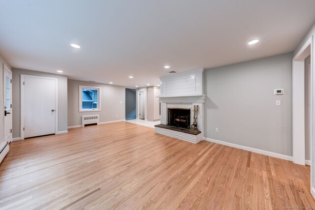 33 White Oak Ln, Woodbridge, CT 06525 - unfurnished living room featuring radiator, a fireplace, recessed lighting, light wood-type flooring, and baseboards