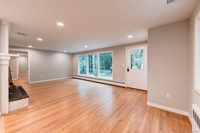 33 White Oak Ln, Woodbridge, CT 06525 - unfurnished living room featuring a baseboard heating unit, baseboards, recessed lighting, and light wood-style floors