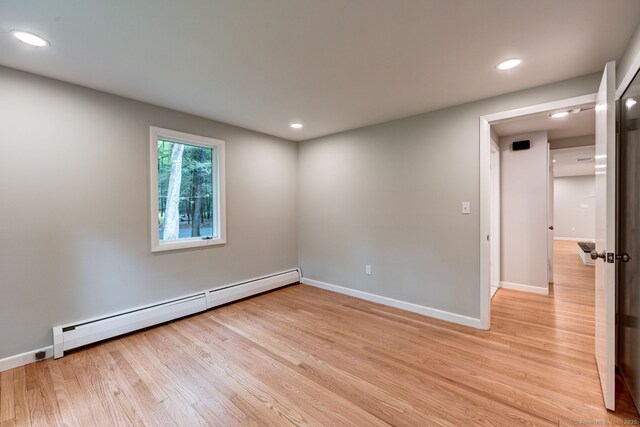 33 White Oak Ln, Woodbridge, CT 06525 - empty room with a baseboard radiator, light wood-type flooring, recessed lighting, and baseboards