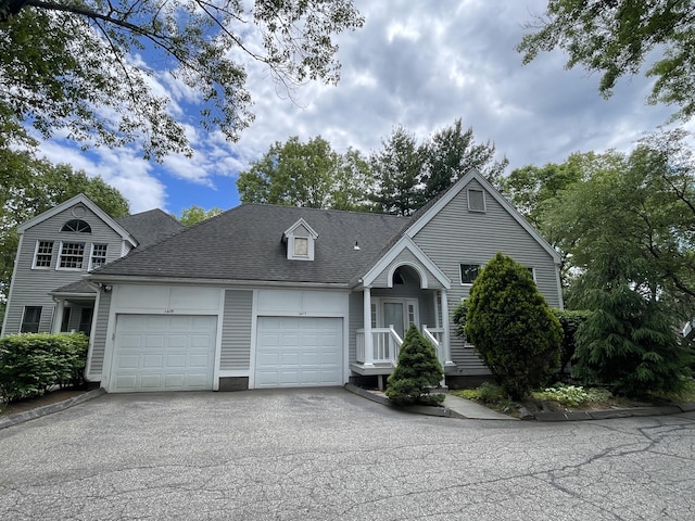 1433 Naugatuck Ave Unit 1433, Milford, CT 06461 - view of front facade featuring a garage, asphalt driveway, and a shingled roof