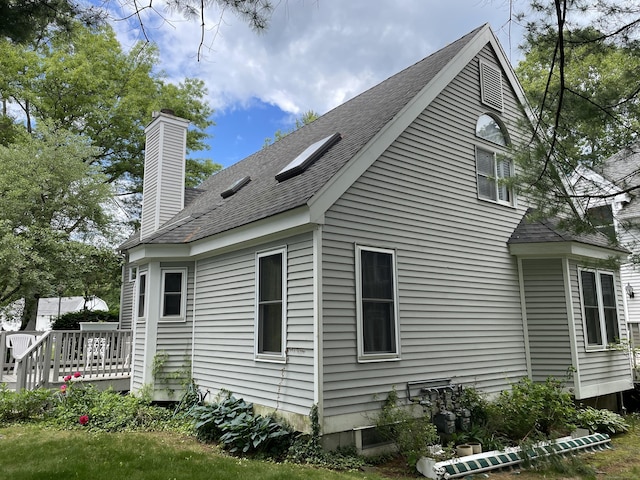 1433 Naugatuck Ave Unit 1433, Milford, CT 06461 - view of side of property with a chimney, a wooden deck, and roof with shingles