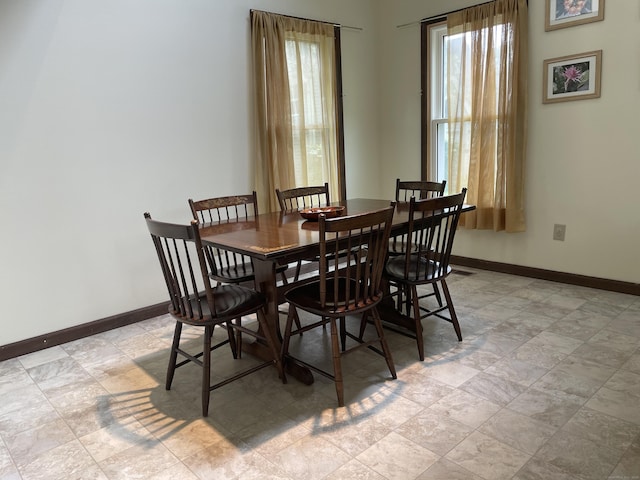 1433 Naugatuck Ave Unit 1433, Milford, CT 06461 - dining room with healthy amount of natural light, baseboards, and light stone finish floors