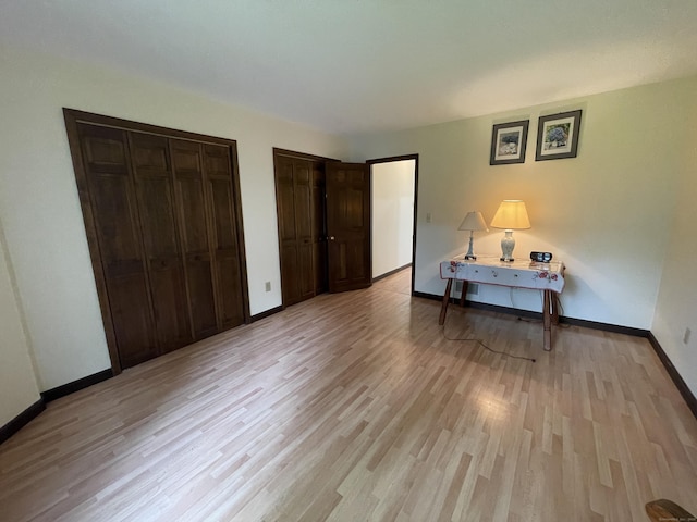1433 Naugatuck Ave Unit 1433, Milford, CT 06461 - bedroom with two closets, light wood-style flooring, and baseboards