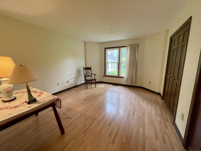 1433 Naugatuck Ave Unit 1433, Milford, CT 06461 - living area featuring light wood finished floors and baseboards