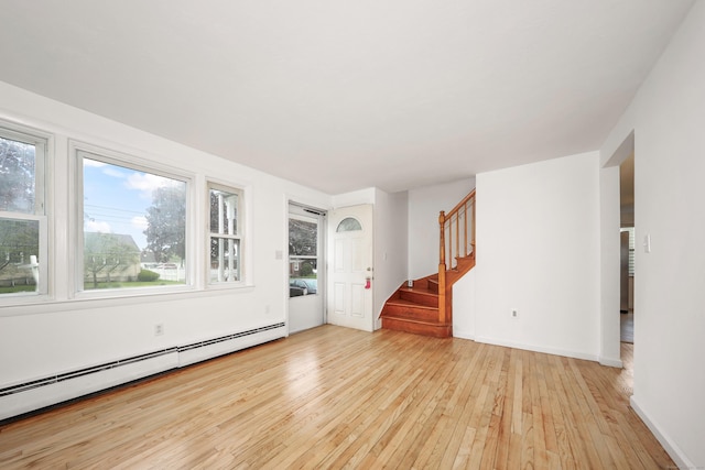 166 Wynola Ave, New Britain, CT 06051 - unfurnished living room featuring a baseboard heating unit, light wood finished floors, plenty of natural light, and stairs