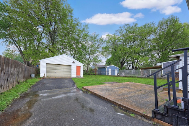 166 Wynola Ave, New Britain, CT 06051 - view of yard featuring an outdoor structure, a garage, and driveway