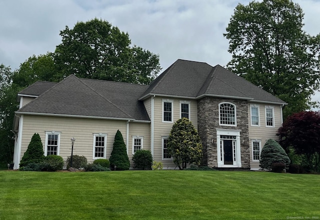37 Ellsworth Ln, Ellington, CT 06029 - view of front of house featuring a front yard, stone siding, and a shingled roof