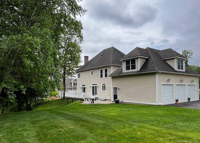 37 Ellsworth Ln, Ellington, CT 06029 - back of property featuring a yard, asphalt driveway, and a wooden deck