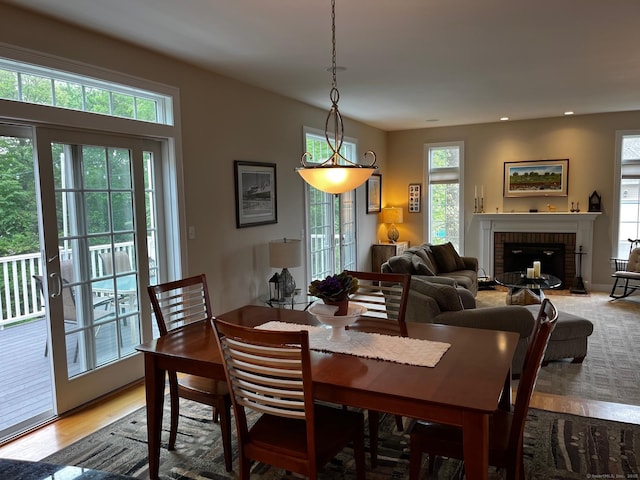 37 Ellsworth Ln, Ellington, CT 06029 - dining room with light wood-style flooring, a brick fireplace, and recessed lighting