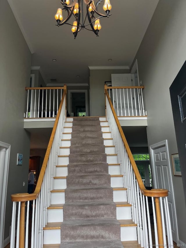 37 Ellsworth Ln, Ellington, CT 06029 - stairway featuring a chandelier, a towering ceiling, and crown molding