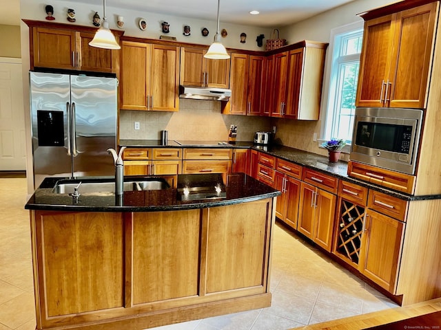 37 Ellsworth Ln, Ellington, CT 06029 - kitchen with stainless steel appliances, under cabinet range hood, an island with sink, and dark stone countertops