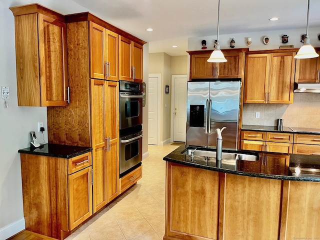 37 Ellsworth Ln, Ellington, CT 06029 - kitchen with stainless steel appliances, under cabinet range hood, dark stone counters, tasteful backsplash, and brown cabinets