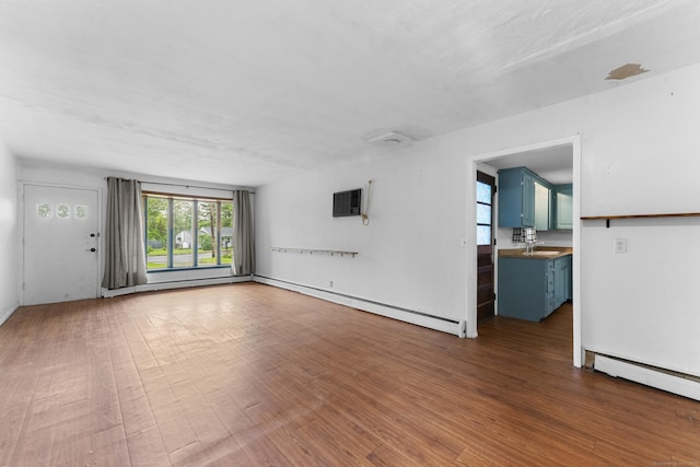 4 Meadow Rd, Enfield, CT 06082 - unfurnished living room featuring a baseboard radiator, wood finished floors, a sink, and an AC wall unit