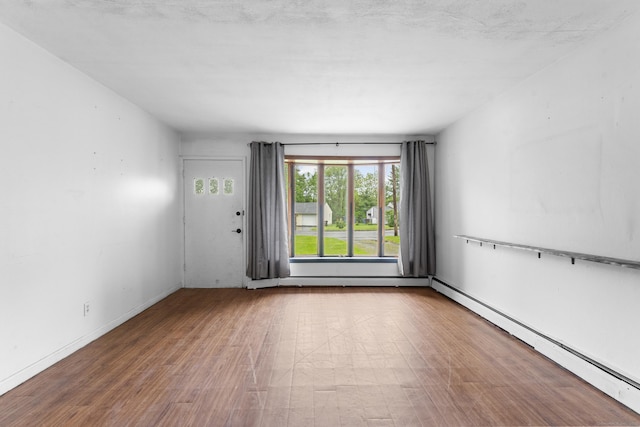 4 Meadow Rd, Enfield, CT 06082 - spare room with a baseboard heating unit, wood finished floors, and baseboards