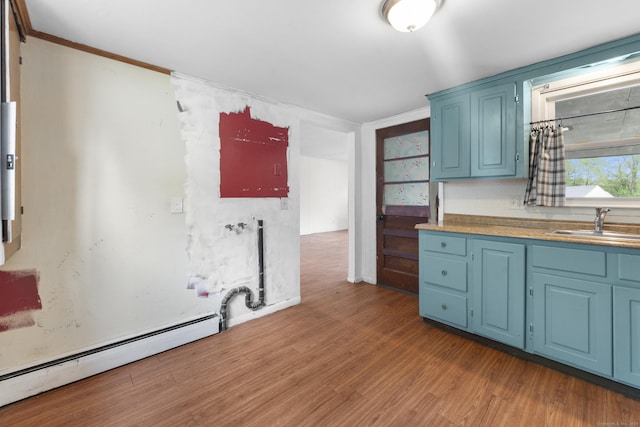 4 Meadow Rd, Enfield, CT 06082 - kitchen featuring blue cabinetry, light wood-type flooring, crown molding, and a sink