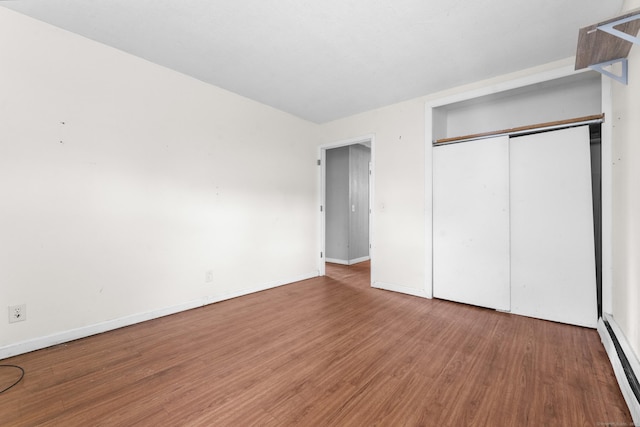 4 Meadow Rd, Enfield, CT 06082 - unfurnished bedroom featuring wood finished floors, a baseboard radiator, baseboards, and a closet