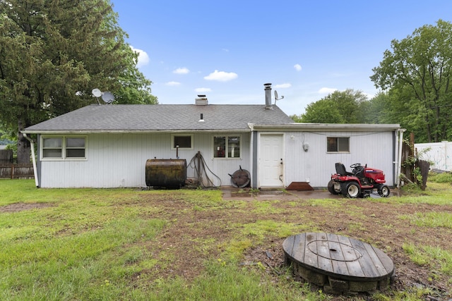4 Meadow Rd, Enfield, CT 06082 - rear view of house with oil tank, a fire pit, a chimney, and roof with shingles
