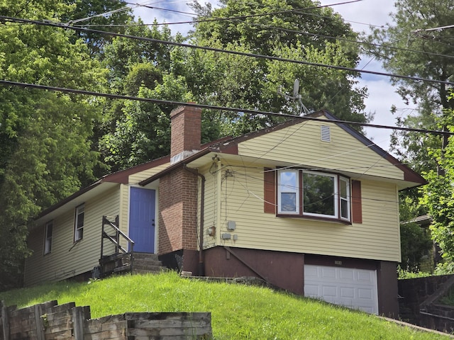184 Clark St, New Britain, CT 06051 - view of front facade with entry steps, a chimney, and an attached garage