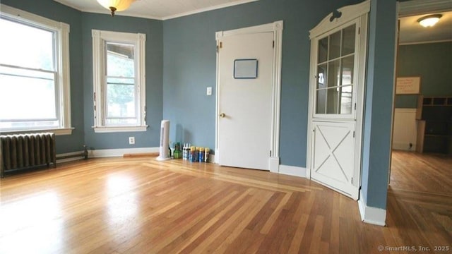 48 Moore Ave, New London, CT 06320 - unfurnished room featuring radiator heating unit, crown molding, wood finished floors, and baseboards