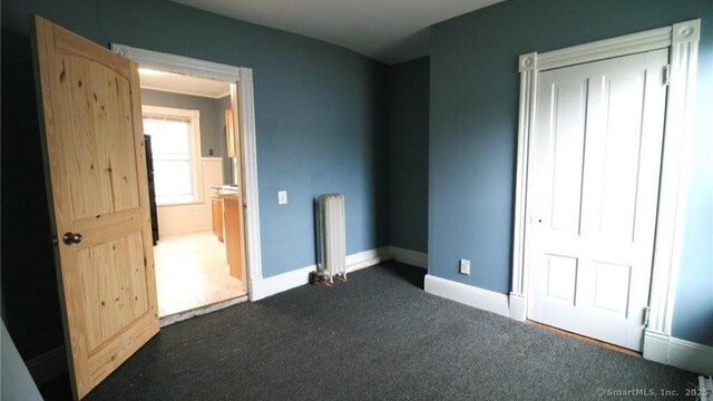 48 Moore Ave, New London, CT 06320 - unfurnished bedroom with radiator heating unit, carpet, and baseboards