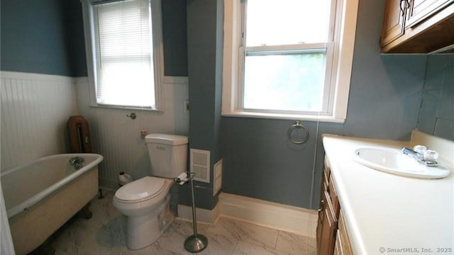 48 Moore Ave, New London, CT 06320 - full bathroom with a soaking tub, vanity, a wainscoted wall, healthy amount of natural light, and toilet