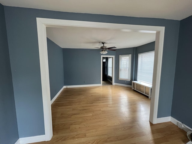 48 Moore Ave, New London, CT 06320 - empty room with radiator, wood finished floors, baseboards, and ceiling fan