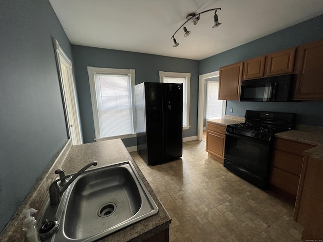 48 Moore Ave, New London, CT 06320 - kitchen featuring black appliances, a sink, brown cabinets, and light flooring