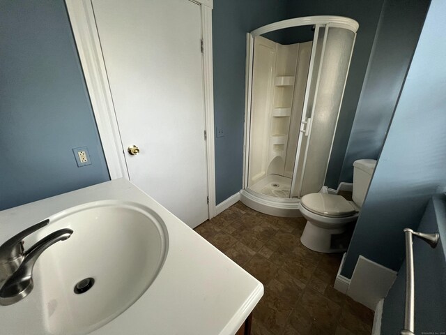 48 Moore Ave, New London, CT 06320 - bathroom featuring a stall shower, toilet, baseboards, vanity, and stone finish floors