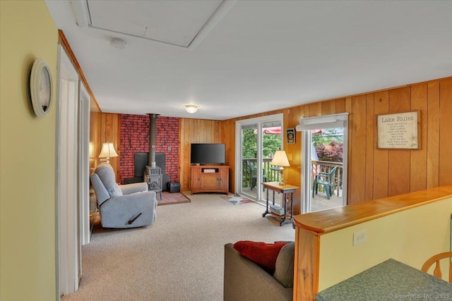 124 Deepwood Dr, Hebron, CT 06231 - carpeted living room featuring a wood stove and wood walls