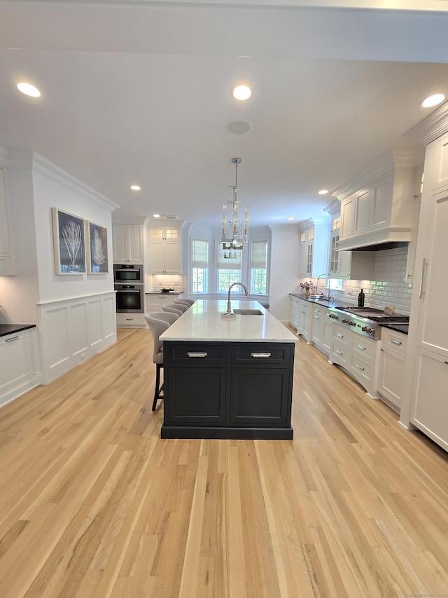 20 Crawford Rd, Westport, CT 06880 - kitchen featuring white cabinets, dark cabinetry, a sink, crown molding, and recessed lighting