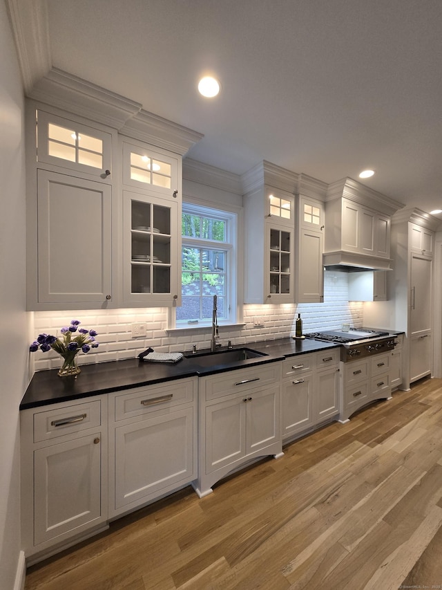 20 Crawford Rd, Westport, CT 06880 - kitchen featuring a sink, premium range hood, crown molding, light wood-type flooring, and white cabinetry