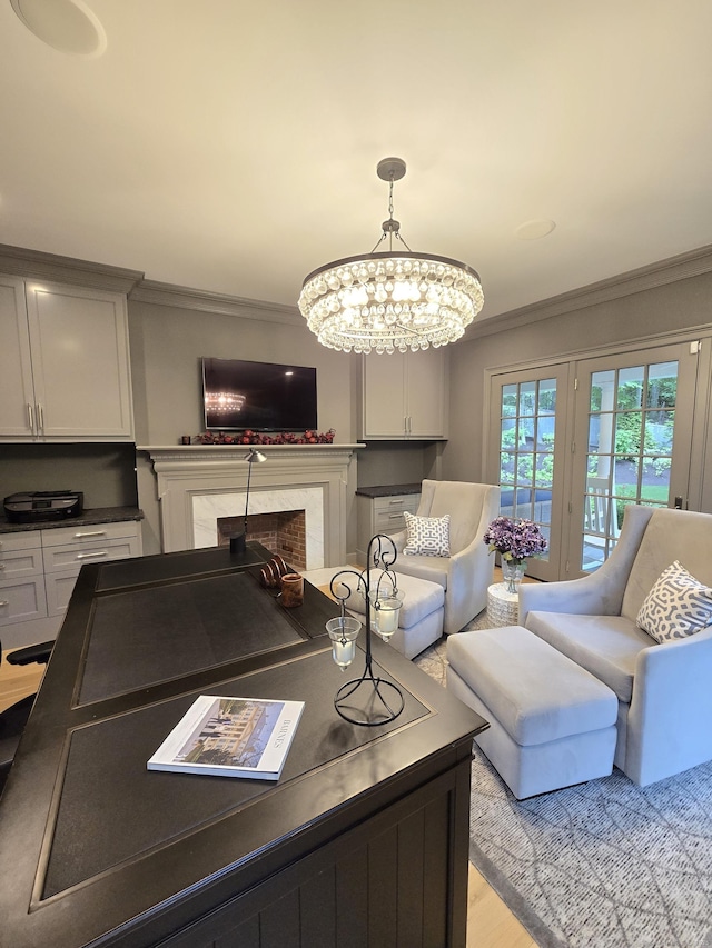20 Crawford Rd, Westport, CT 06880 - living room with ornamental molding, a high end fireplace, light wood-style flooring, and a chandelier