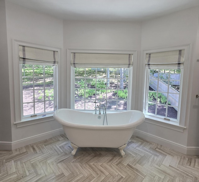 20 Crawford Rd, Westport, CT 06880 - bathroom with baseboards, a soaking tub, and healthy amount of natural light