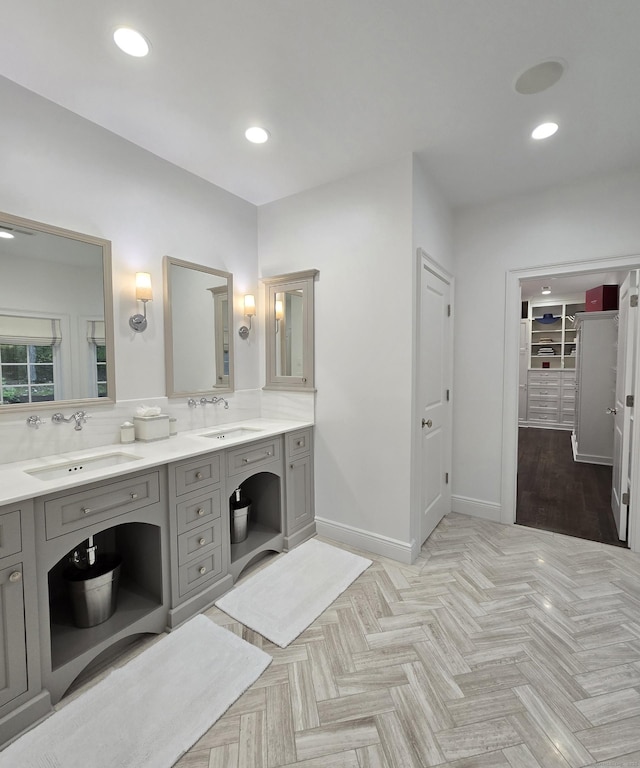 20 Crawford Rd, Westport, CT 06880 - bathroom featuring double vanity, a walk in closet, baseboards, and recessed lighting