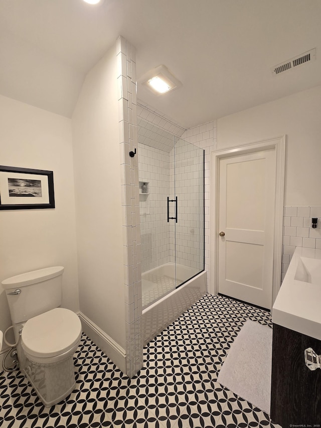 20 Crawford Rd, Westport, CT 06880 - full bathroom featuring combined bath / shower with glass door, toilet, vanity, lofted ceiling, and baseboards