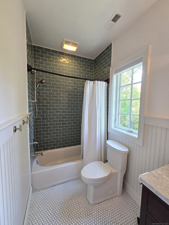 20 Crawford Rd, Westport, CT 06880 - full bathroom with toilet, vanity, shower / bath combination with curtain, wainscoting, and tile patterned floors