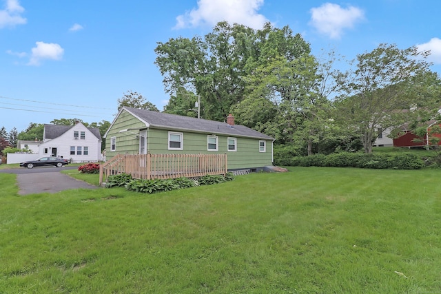 52 Fairview Ave, Bristol, CT 06010 - back of property featuring a deck, a lawn, and a chimney
