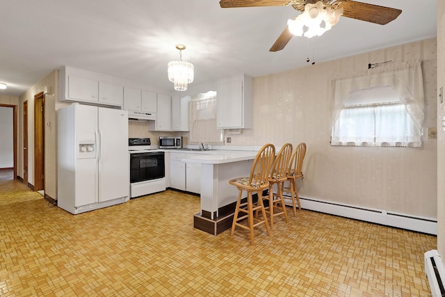 52 Fairview Ave, Bristol, CT 06010 - kitchen with white appliances, under cabinet range hood, white cabinetry, light countertops, and a peninsula