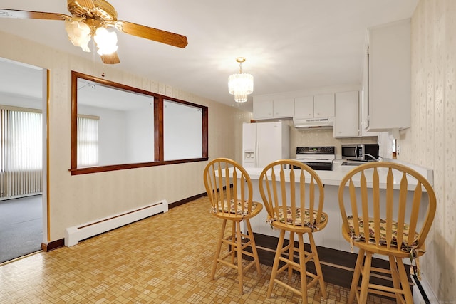52 Fairview Ave, Bristol, CT 06010 - kitchen featuring under cabinet range hood, a baseboard radiator, white appliances, white cabinets, and a peninsula