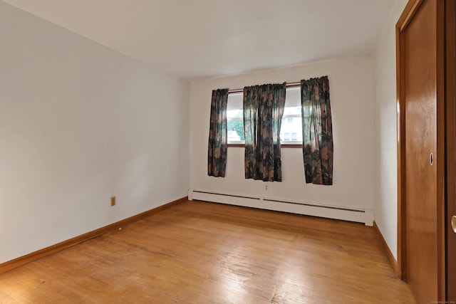 52 Fairview Ave, Bristol, CT 06010 - unfurnished bedroom with a baseboard heating unit, light wood finished floors, and baseboards