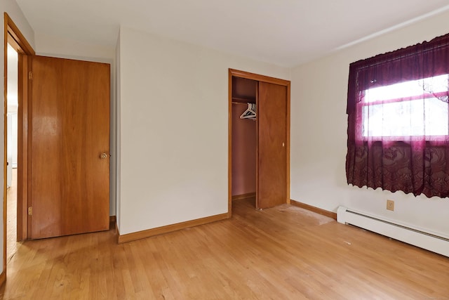 52 Fairview Ave, Bristol, CT 06010 - unfurnished bedroom featuring baseboard heating, wood finished floors, baseboards, and a closet