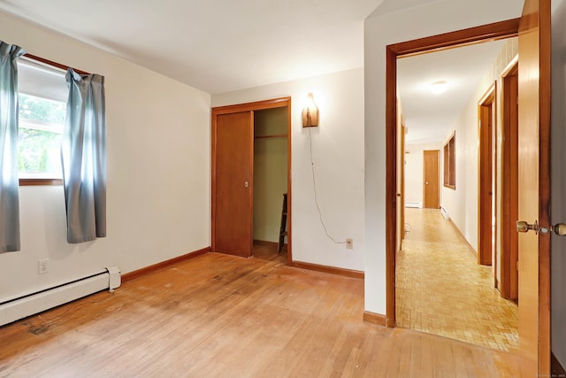 52 Fairview Ave, Bristol, CT 06010 - unfurnished bedroom featuring a baseboard radiator, light wood-style flooring, a closet, and baseboards