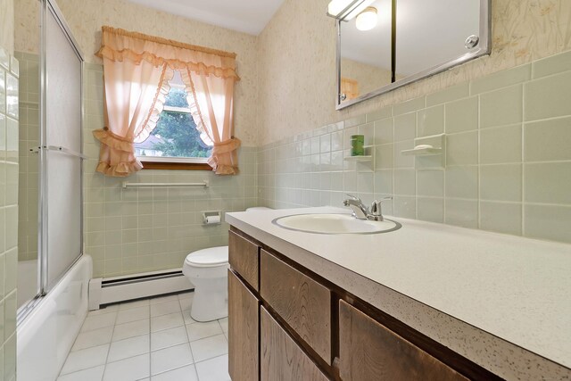 52 Fairview Ave, Bristol, CT 06010 - bathroom with a baseboard radiator, tile patterned floors, tile walls, toilet, and vanity