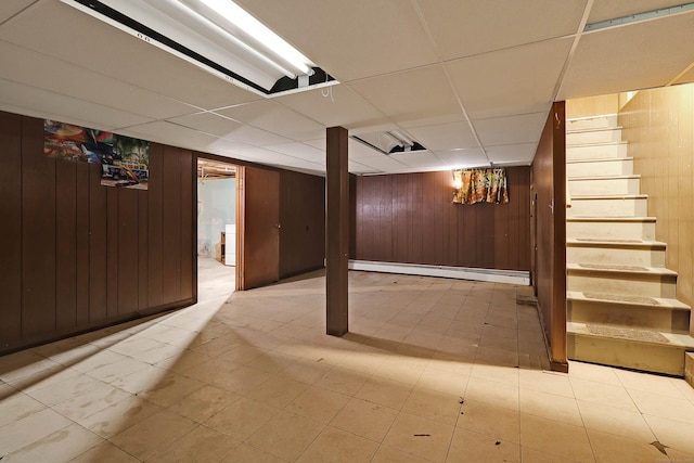 52 Fairview Ave, Bristol, CT 06010 - finished basement with wooden walls, stairway, baseboard heating, and a paneled ceiling
