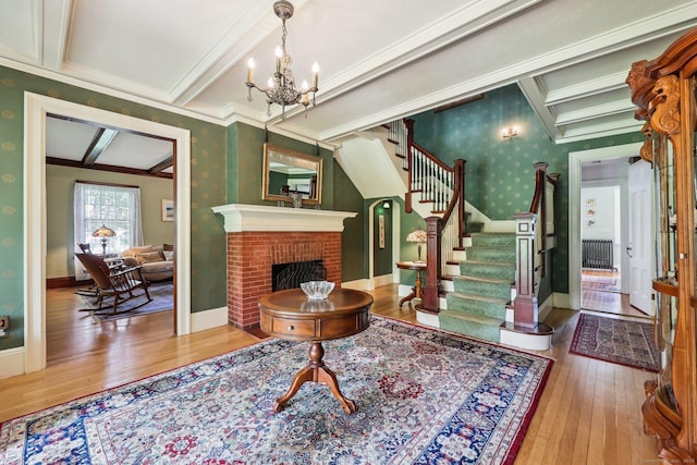 222 N Beacon St, Hartford, CT 06105 - foyer featuring wallpapered walls, hardwood / wood-style floors, a chandelier, stairs, and crown molding