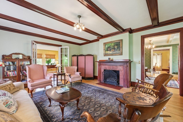222 N Beacon St, Hartford, CT 06105 - living room with a chandelier, ornamental molding, wood finished floors, beam ceiling, and a brick fireplace